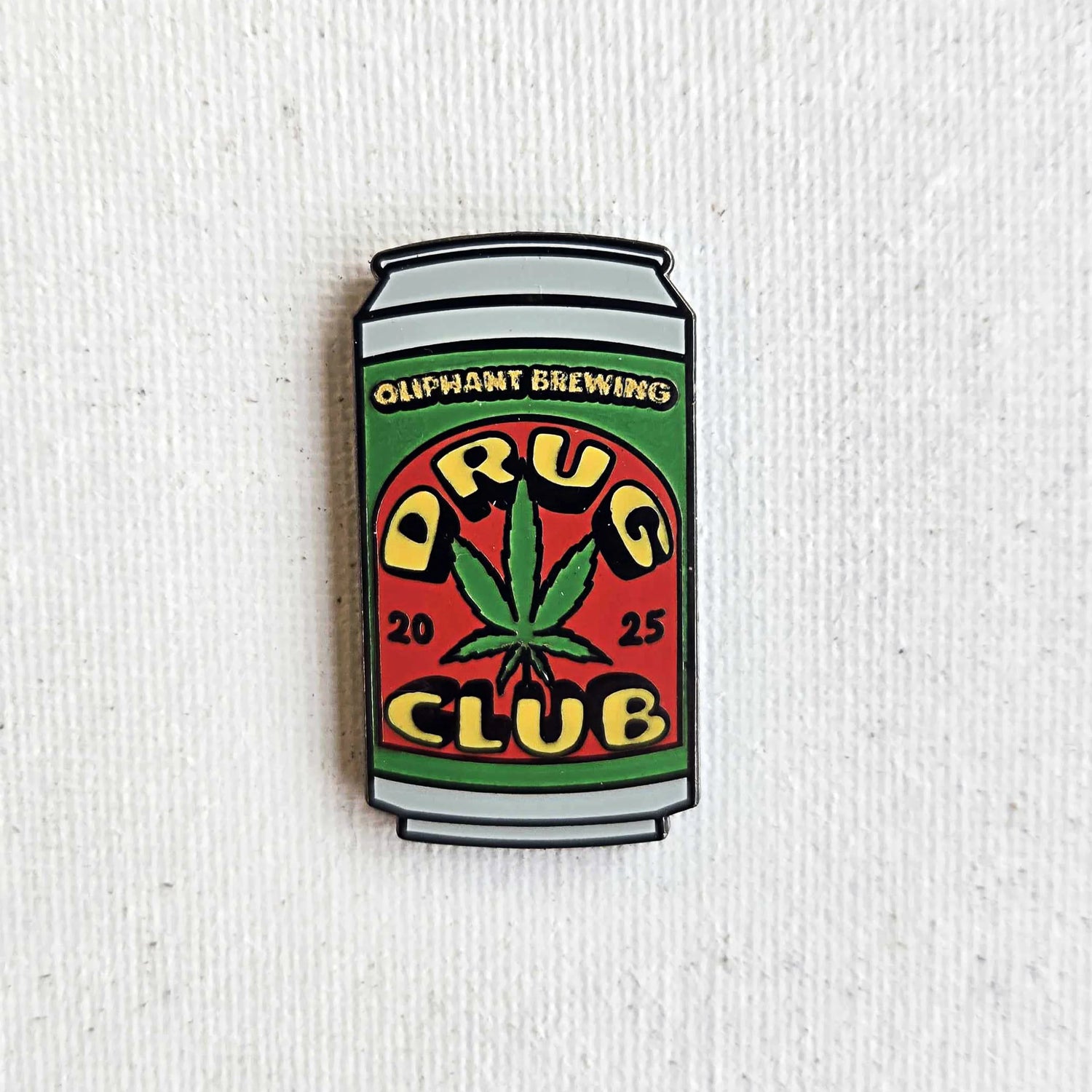 Oliphant Brewing Drug Club enamel pin shaped like a can with a cannabis leaf design