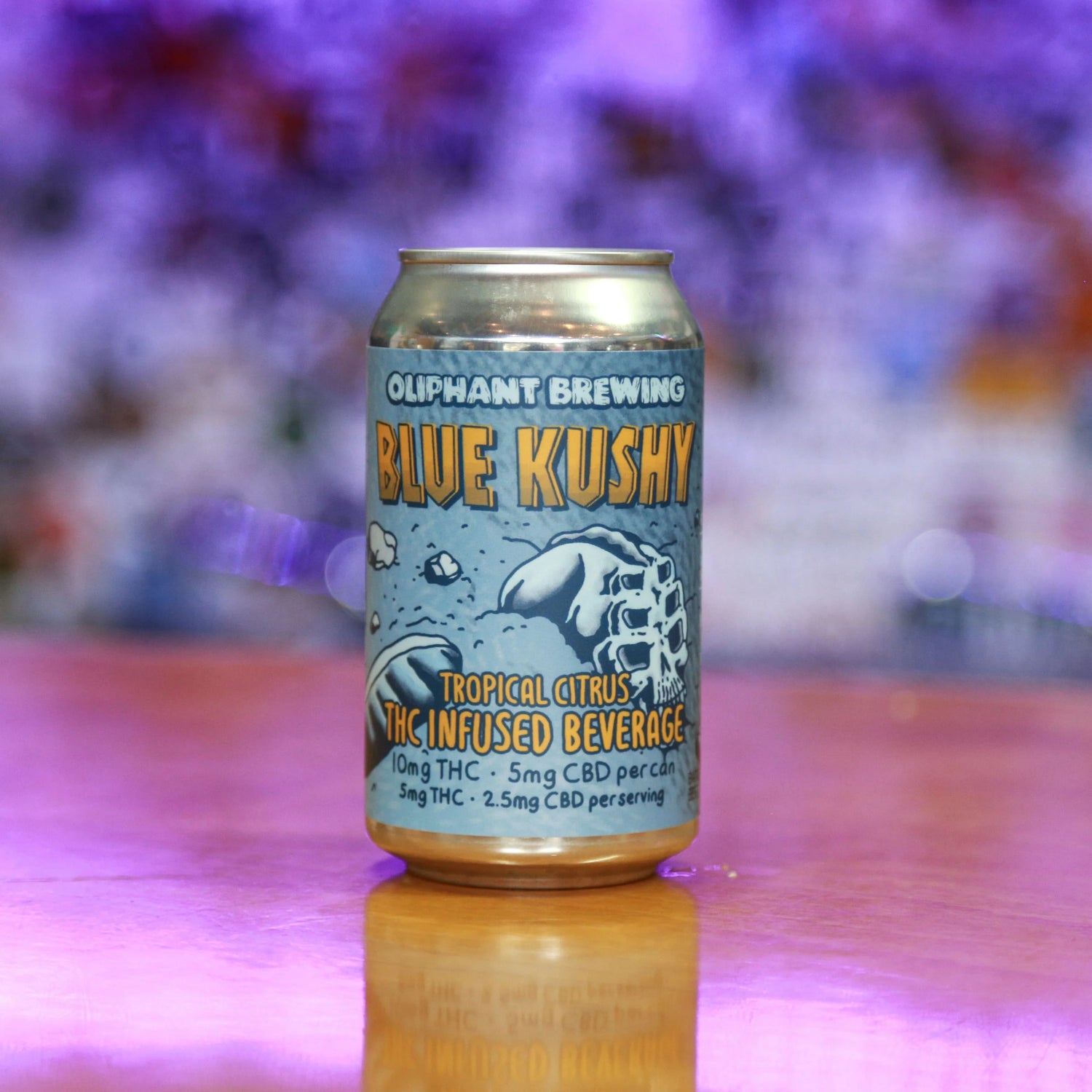 Oliphant Brewing Blue Kushy THC infused tropical citrus beverage can on a reflective surface