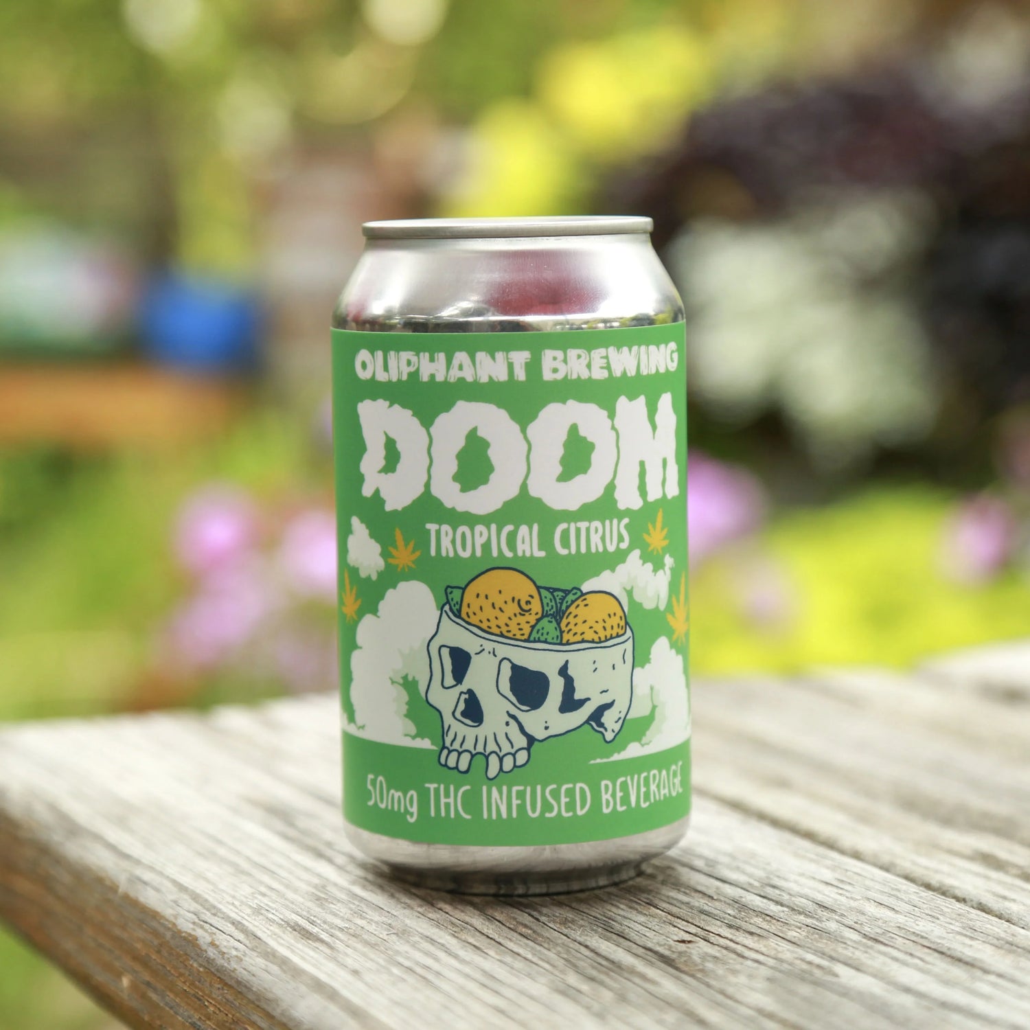 Oliphant Brewing DOOM tropical citrus THC infused beverage can on wooden table outdoors