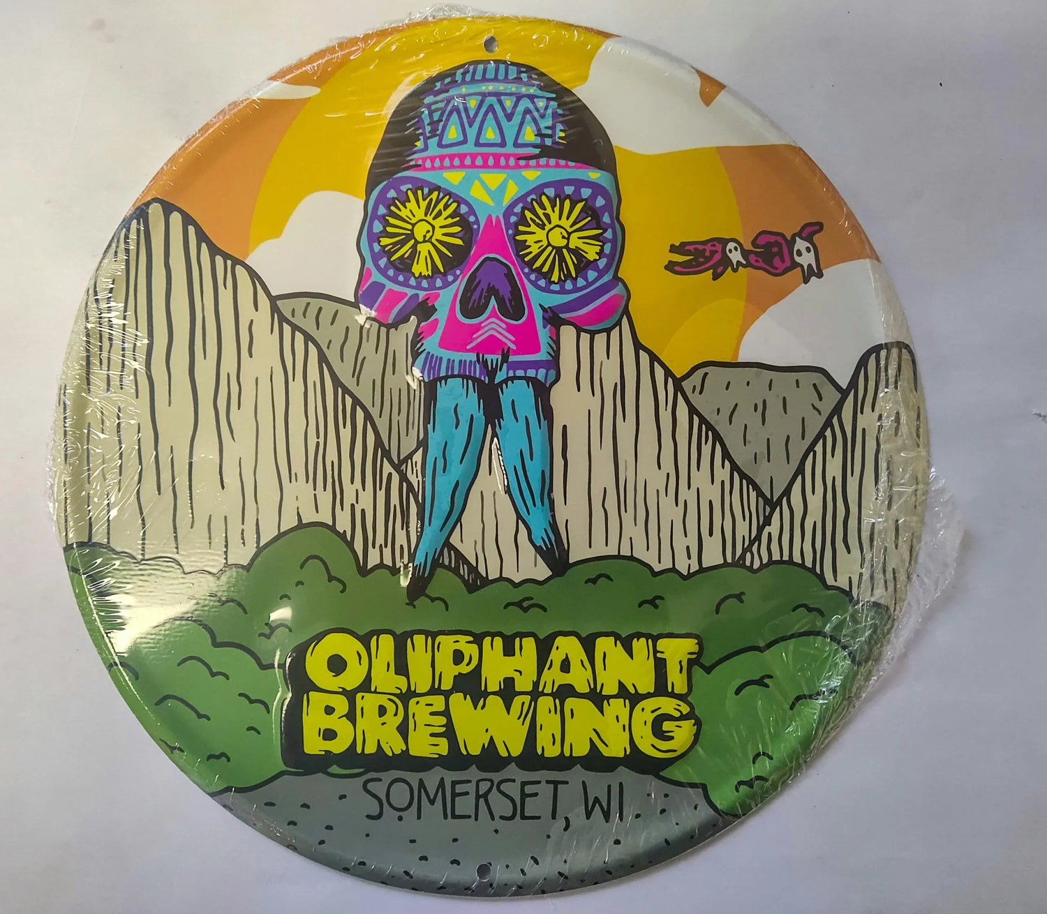 Oliphant Brewing Somerset WI colorful skull art sign with mountains and wrapped edges