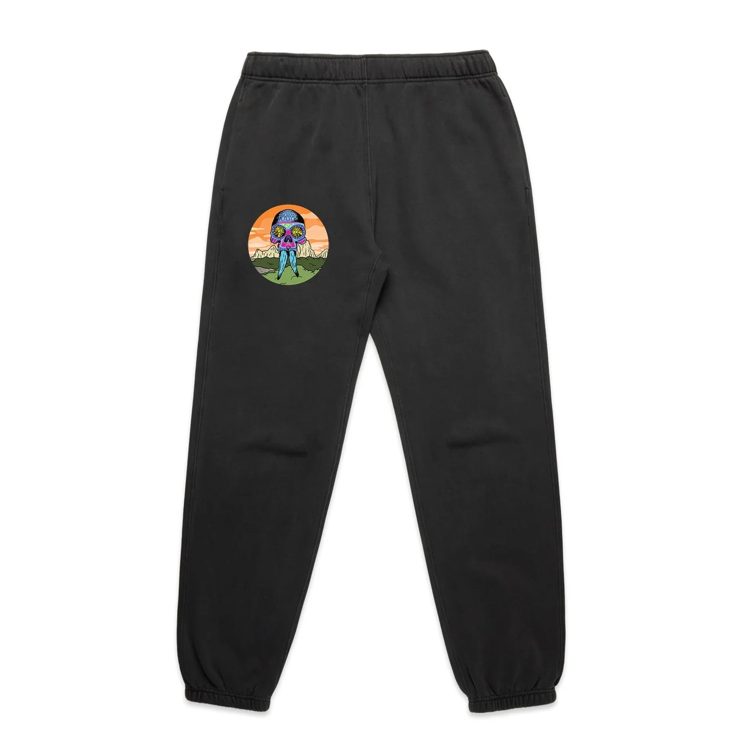 Faded black track pants with colorful skull graphic and nature scene on the left leg